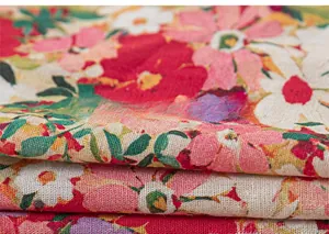 Macro detail of breathable cotton-linen floral fabric with vibrant red and pink prints