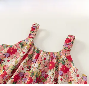 Detail of floral girl dress with elastic pleated shoulder straps and cotton texture