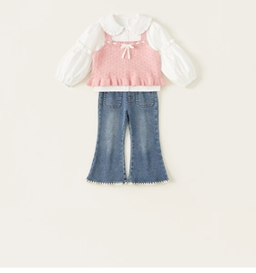 Detail of pink knitted vest with hollow patterns and denim flare pants for girls