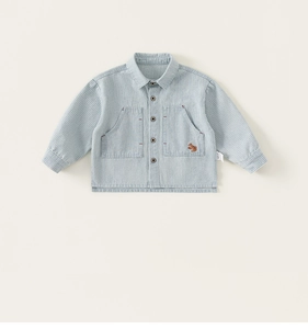 Detailed close-up of blue striped cotton shirt with small squirrel embroidery and buttons