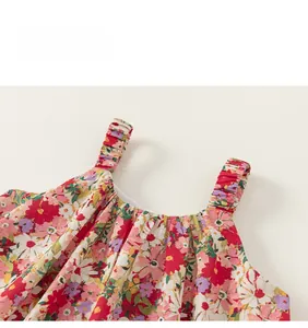 Close-up of elastic ruffled shoulder straps and smocked neckline on floral girls dress