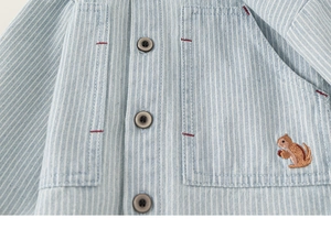 Detail of blue striped toddler shirt with squirrel embroidery and double pockets