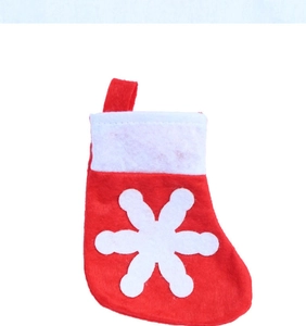 Mini red Christmas stocking cutlery holder with a white snowflake for festive table decor