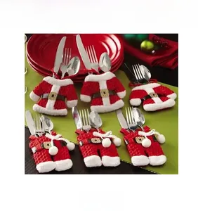 Detail view of red Christmas coat and pants cutlery holders for festive table decor