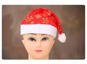 Detail view of the red snowflake Christmas hat with golden glitter and plush white trim
