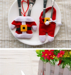 Detail of Christmas sweater and overalls cutlery holders with festive fur trim and belts
