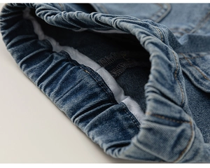 Detail of high-elastic elastic waistband on girls' blue denim flared pants