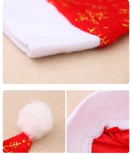 Detail view of red Christmas hat with golden snowflakes, white plush trim and fine stitching