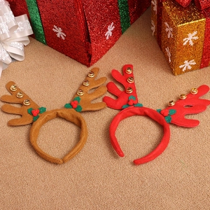 Christmas reindeer antler headband set with gold bells and holly on festive background