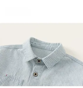 Detail view of boys striped shirt featuring a lapel collar and red pocket stitching