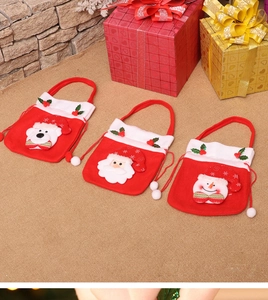 Detailed view of three Christmas gift bags with snowman and Santa felt appliques