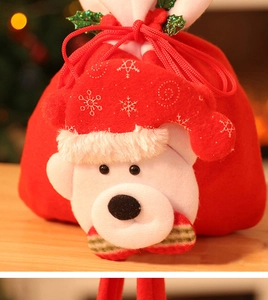 Detail of red Christmas drawstring bag featuring 3D polar bear doll with snowflake hat