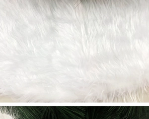 Detail view of plush white faux fur Christmas tree skirt with thick soft texture