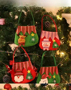 Detail of four festive Christmas felt gift bags featuring Santa, snowman, and reindeer designs