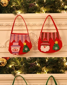 Close-up of red felt Christmas gift bags featuring festive snowman and Santa Claus designs