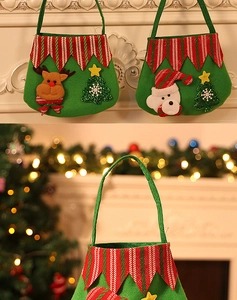 Detail view of green felt Christmas gift bags with 3D reindeer and Santa Claus appliques