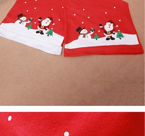 Detail view of red Christmas chair covers featuring Santa and Snowman felt prints