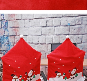 Close-up of red Christmas chair covers with Santa Claus, snowman and tree prints