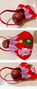 Macro view of Christmas felt apple bag with snowman ornament and festive sequins