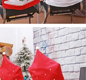 Detail of red Santa hat chair covers with white plush pom-poms for festive dining decor