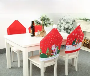 Close-up of red non-woven Christmas chair covers with festive prints and plush white balls