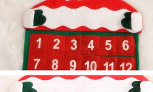 Detail of red felt Christmas countdown calendar with white numbered pockets and wavy trim