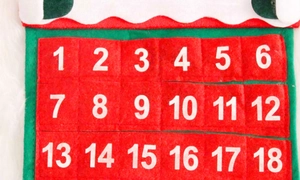 Close-up of felt Christmas advent calendar showing numbered pockets 1-18 for holiday countdown