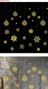 Detailed view of premium gold snowflake and star static window stickers for Christmas decor
