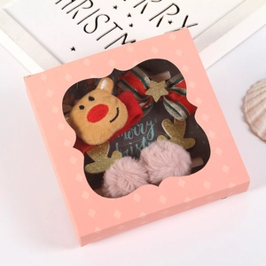 Christmas hair accessory gift set including reindeer headbands and bow clips in pink box