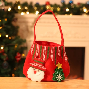 Red felt Christmas gift bag featuring Santa Claus and green sequin tree on wooden desk