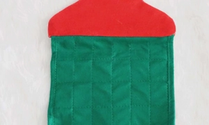 Close-up of a quilted Christmas countdown calendar fabric with red and green felt textures