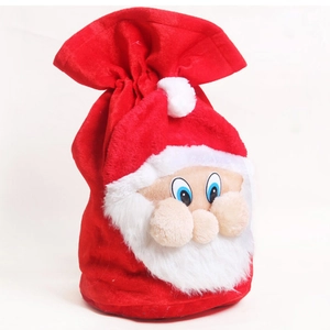 Vue détaillée du sac cadeau de Noël en velours rouge avec motif Père Noël en 3D
