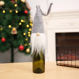 Festive Christmas gnome wine bottle cover with grey felt hat and white faux fur beard