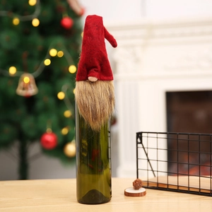 Christmas gnome wine bottle cover with red felt hat and brown beard for festive decor