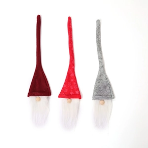Three Christmas gnomes in red, grey, and snowflake patterns with long white fiber beards