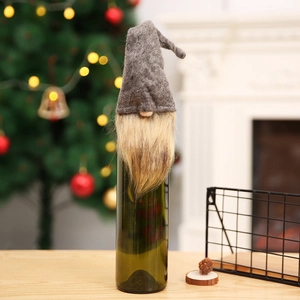 Detail of Christmas gnome wine bottle cover with grey felt hat and long golden beard