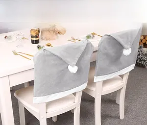 Detail of gray non-woven Christmas chair covers with white plush pom-pom and festive trim