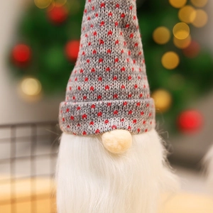 Detail of a Christmas gnome bottle cover featuring a grey knit hat and white faux fur beard