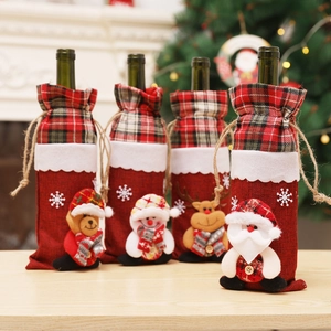 Detail of Christmas wine bottle covers featuring Santa, snowman, and reindeer doll motifs