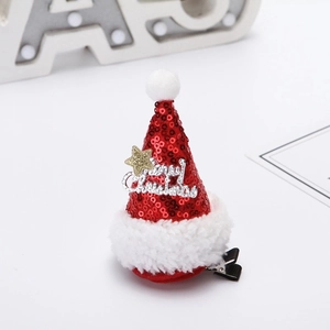Detail of red sequined Christmas hat hair clip with Merry Christmas lettering and fur ball