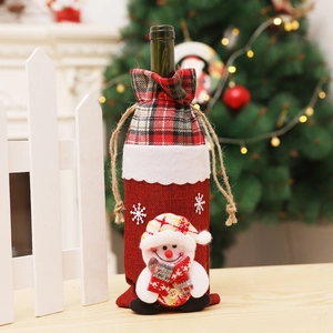Detail of Christmas wine bottle cover with plush snowman and red snowflake patterns