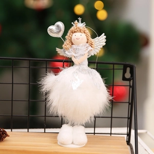 Detailed view of plush white Christmas angel doll with feather skirt and silver wings