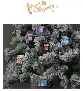 Close-up of wooden LED Christmas house ornament with Santa and reindeer laser-cut details