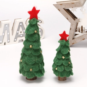 Detail of felt Christmas tree ornaments with red stars, gold bells and wooden bases
