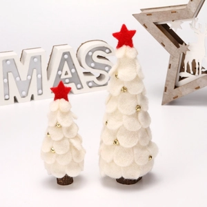 Detail of white felt Christmas trees with red stars, gold bells and wood bases