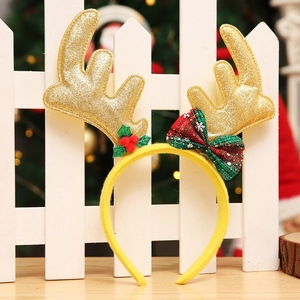 Detail von Weihnachts-Rentier-Geweih-Stirnband mit goldenem Glitzer und karierter Schleife