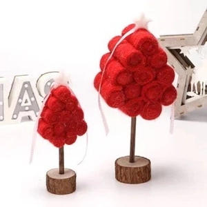 Set of two handcrafted red felt Christmas tree ornaments with wooden bases and white stars