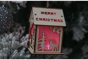 Close-up of wooden LED Christmas house ornament with Merry Christmas deer cutout
