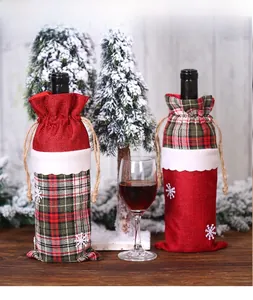 Detail of burlap Christmas wine bottle bags with snowflake embroidery and drawstring