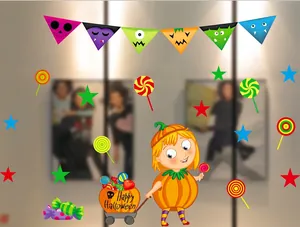 Close-up of Halloween window decals featuring a girl in pumpkin suit and candy cart graphics